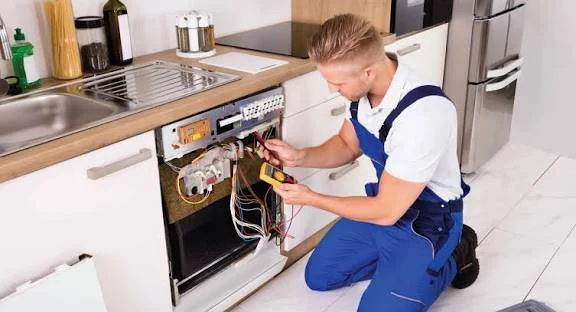 Technician troubleshooting wiring inside a dishwasher door