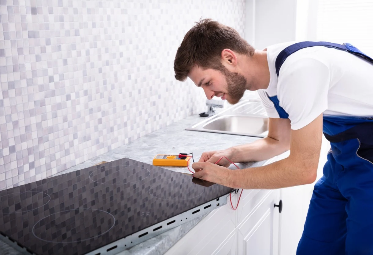Technician testing an electric cooktop